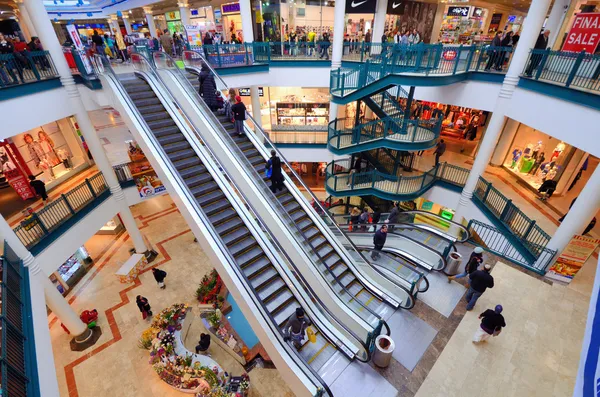Centro comercial con múltiples niveles y mensaje sobre variedad de locales disponibles.